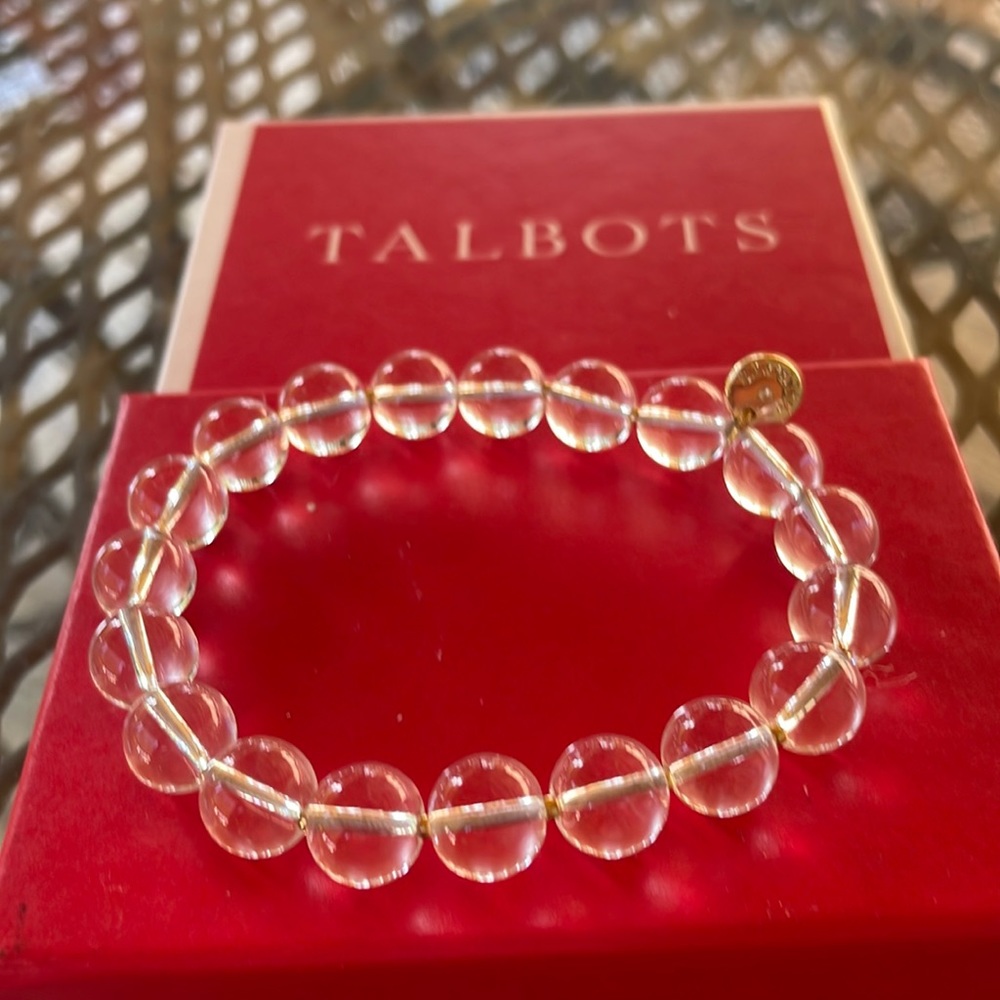 Two bracelets from Talbots , one is clear and the other is blue stones .